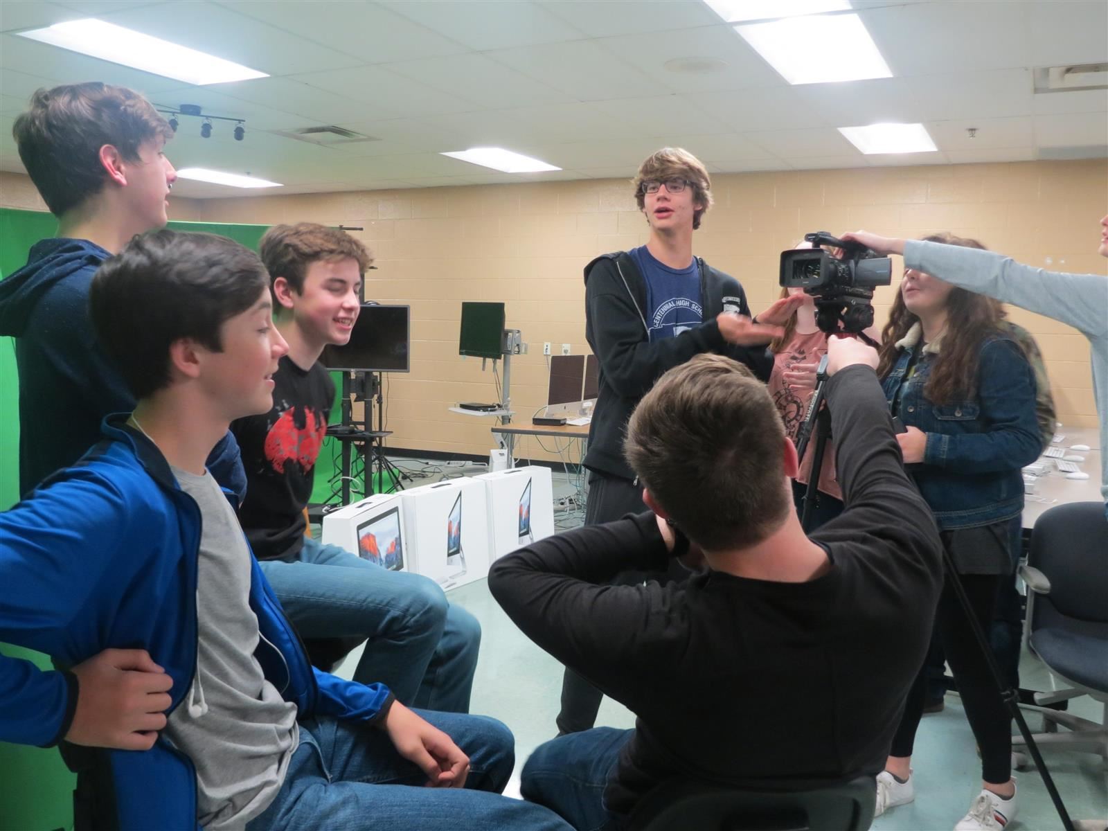 Students discussing how to produce a video shoot.